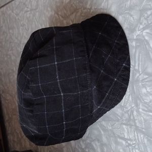 Reversible hat: black soft corduroy on one side red with stripes on the other